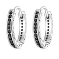 Pair of silver hoop earrings with black gemstones on a white background