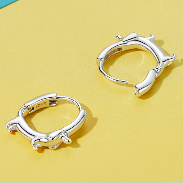 Silver hoop earrings on a yellow background with text about jewelry quality.