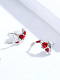 Pair of red and silver fish-shaped earrings on a white background