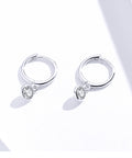 Silver hoop earrings with heart-shaped gemstones on a white background