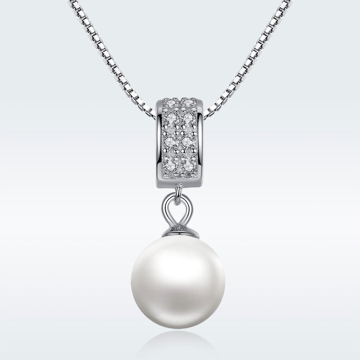 Pearl necklace with diamond pendant on a white background