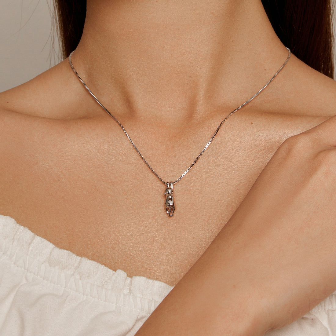 Silver necklace with a unique pendant on a white background