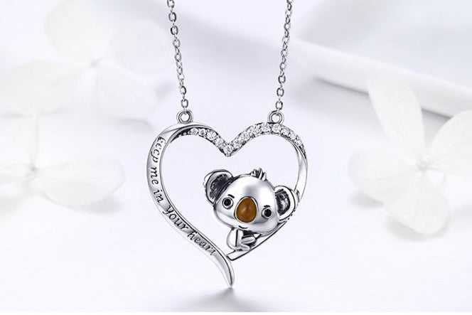 Silver necklace with a koala pendant on a white background