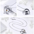 Silver heart-shaped necklace with embedded gemstones on a white background