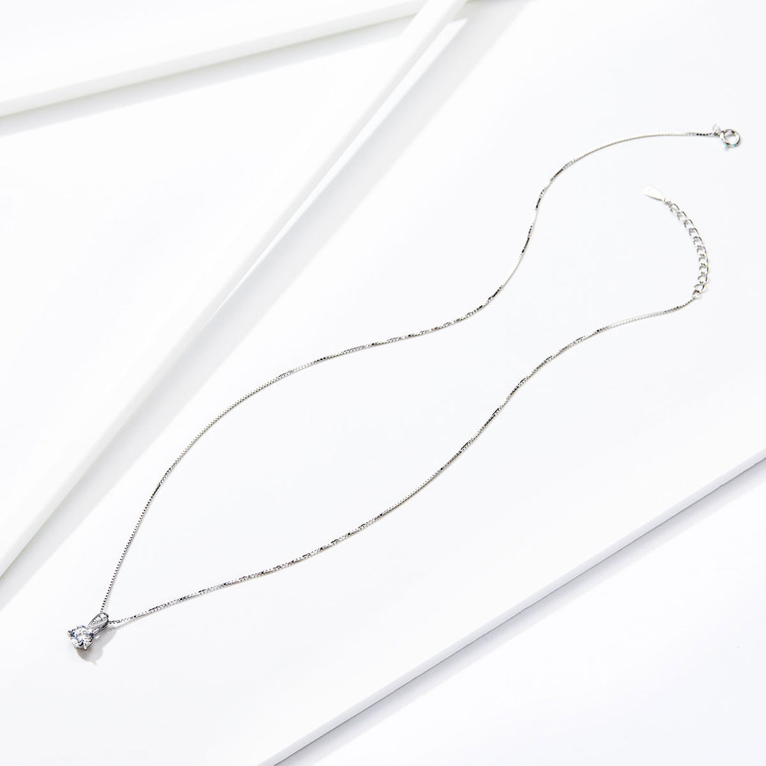 Diamond necklace on a light gray background