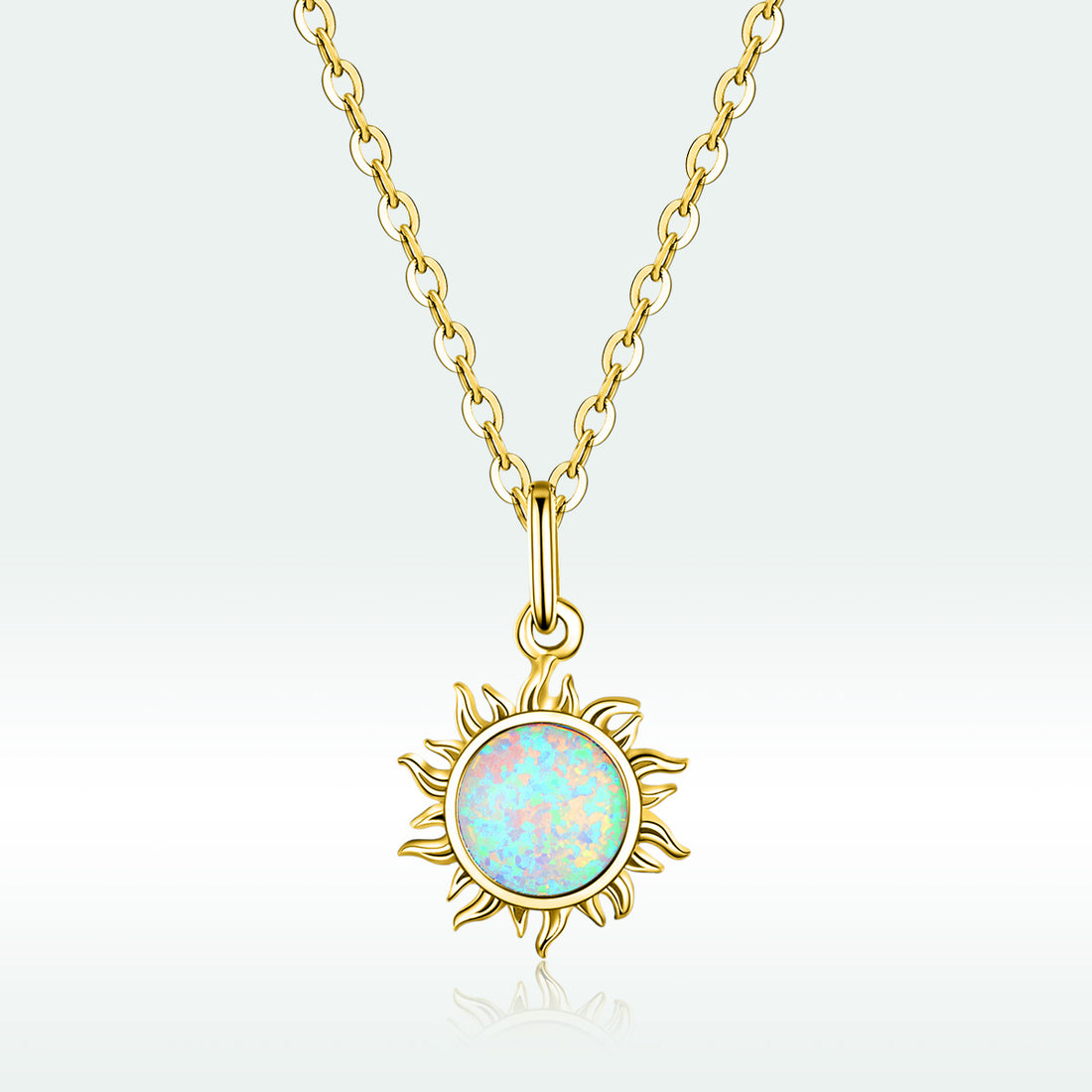 Gold necklace with a sun-shaped pendant featuring an opal stone on a light gray background