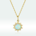 Gold necklace with a sun-shaped pendant featuring an opal stone on a light gray background