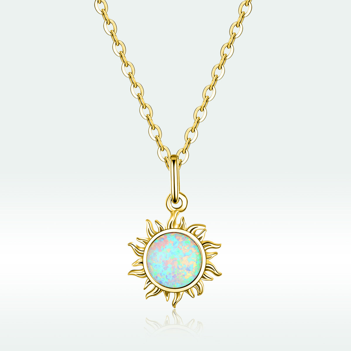 Gold necklace with a sun-shaped pendant featuring an opal stone on a light gray background