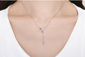 Necklace with a heart pendant worn by a person, with a motivational quote below.