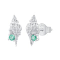 Silver shell earrings with green gemstones on a white background